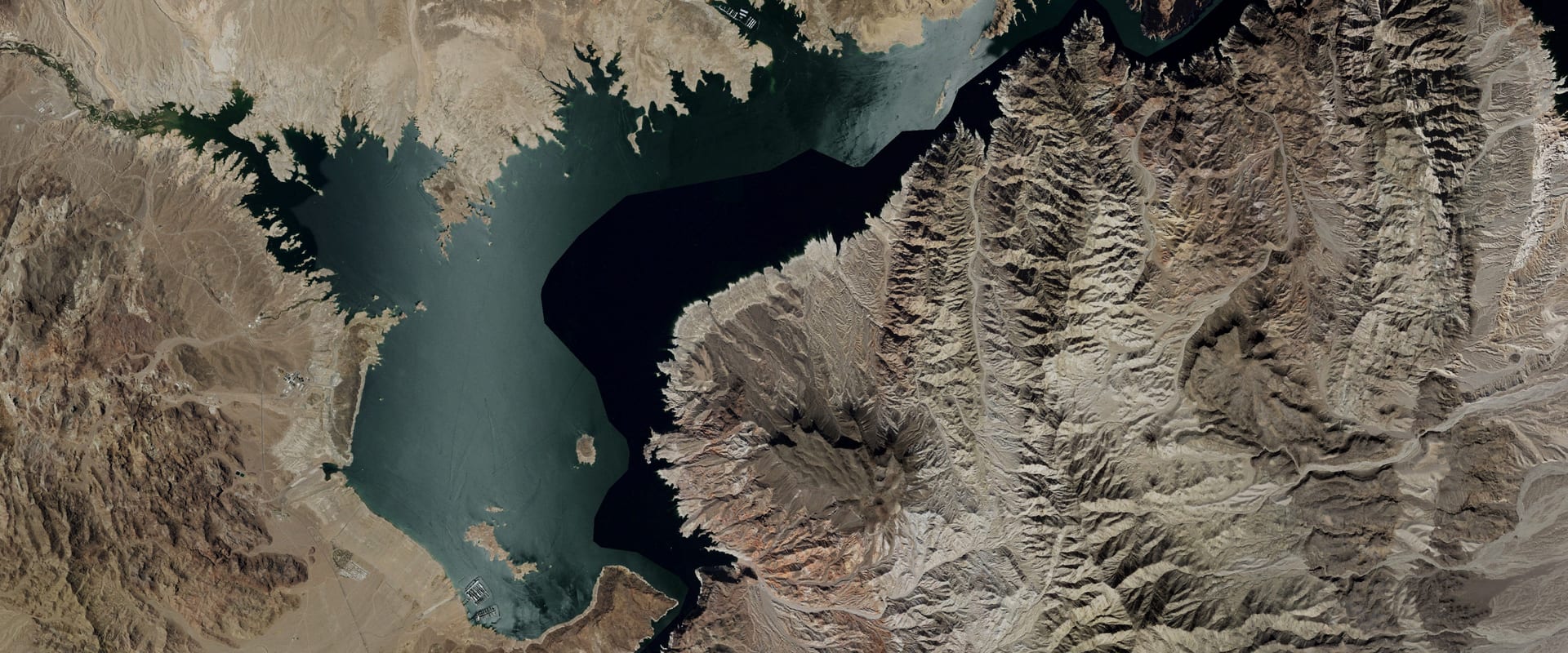 Aerial photo of Boulder Basin on Lake Mead, dark water among bare desert ridges, with a pale band of old shoreline above the water